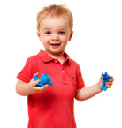 Child in a red shirt holding blue toys against a white background