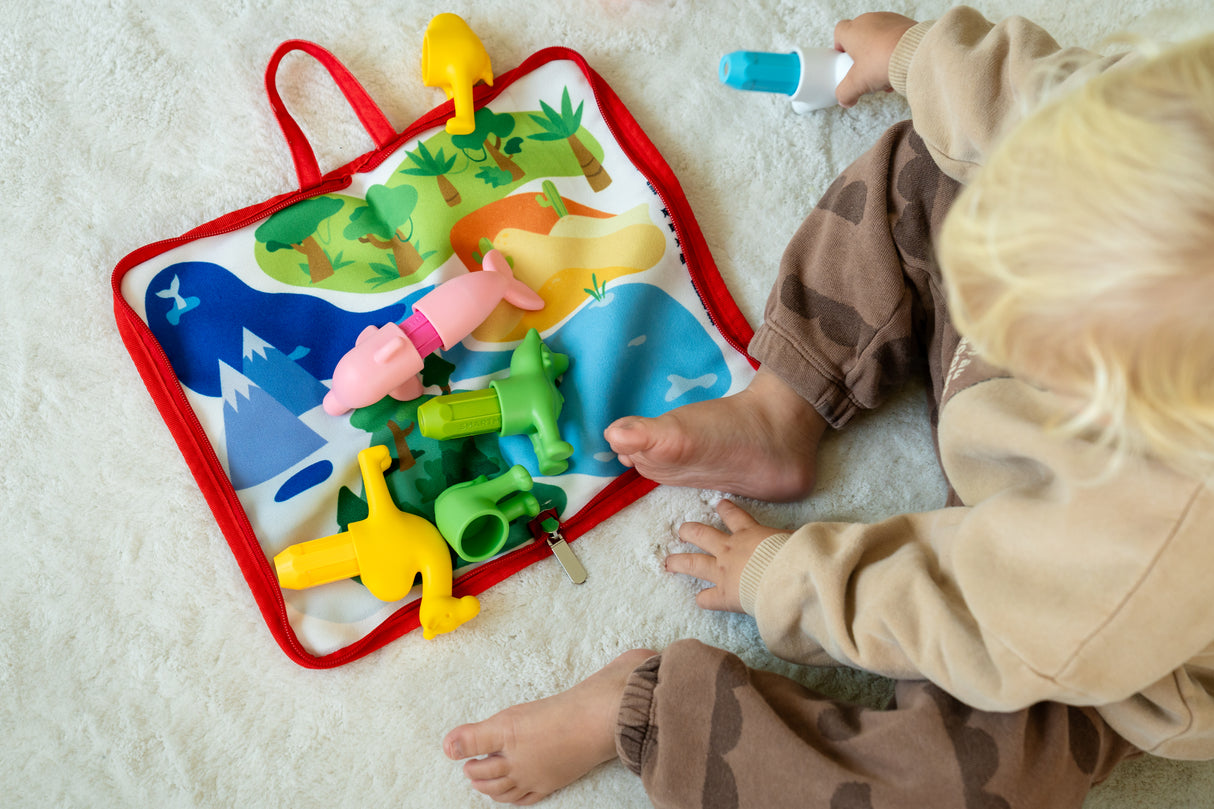 Child playing with a colorful educational toy on a light-colored floor.