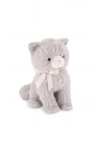 A soft grey plush kitten toy sitting upright, featuring a cream-colored muzzle with delicate embroidered facial details and a white satin ribbon bow tied around its neck.