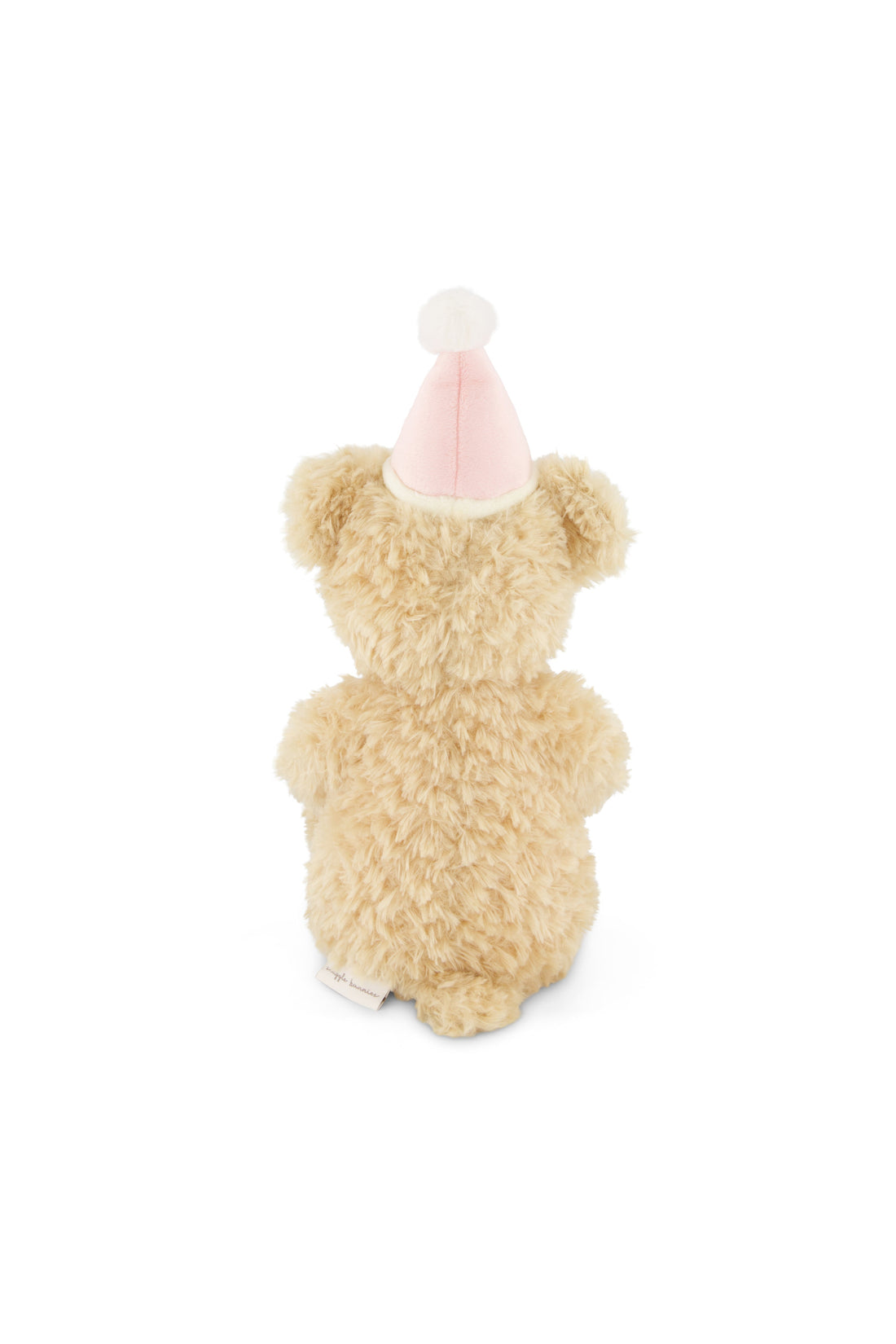 Small teddy bear wearing a pink party hat on a white background