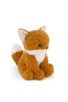 Plush toy fox with fluffy rust-colored and natural-toned fur, a soft cream-colored chest, small dark eyes, a stitched black nose, and a gentle expression, sitting upright against a plain white background.