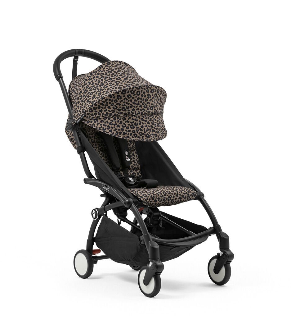 Black stroller with leopard print canopy on a white background