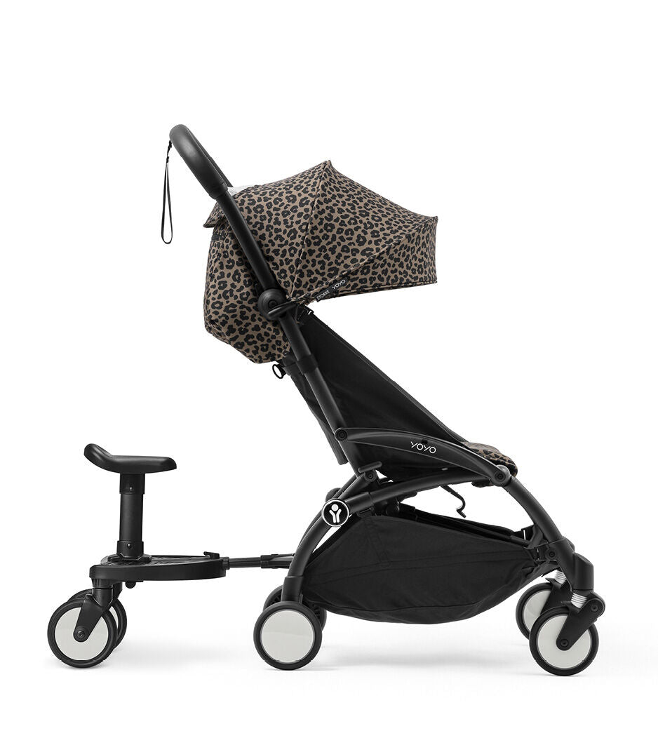 Black stroller with leopard print canopy on a white background