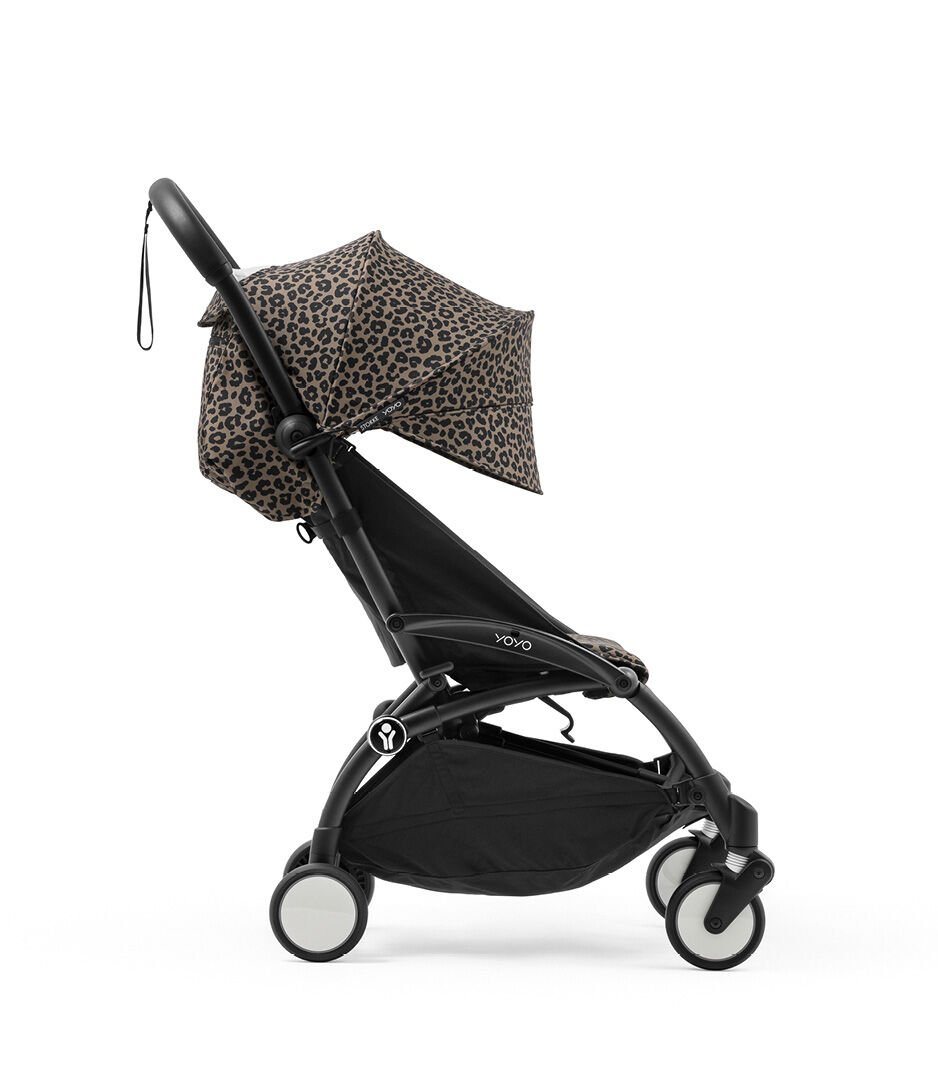 Black stroller with leopard print canopy on a white background
