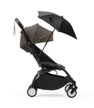 Black stroller with leopard print canopy and black umbrella on a white background