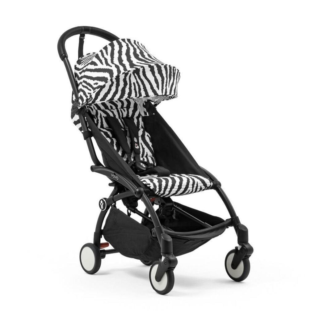 Black and zebra-patterned baby stroller on a white background