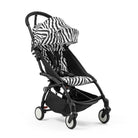 Black and zebra-patterned baby stroller on a white background