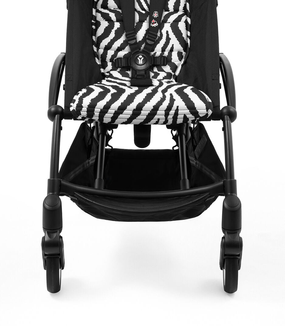 Black stroller with zebra-patterned seat on a white background