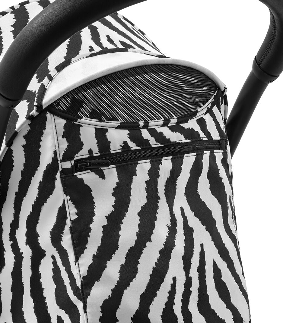 Close-up of a baby stroller with zebra pattern canopy