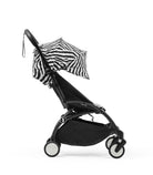Black stroller with zebra-patterned canopy on a white background