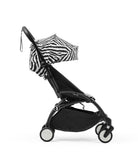 Black stroller with zebra-patterned canopy on a white background