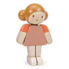 Wooden toy figure of a girl with orange top and beige skirt on a white background