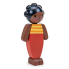 Wooden toy figure of a girl with an orange dress on a white background