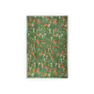 Green blanket with mushroom and flower pattern on a white background