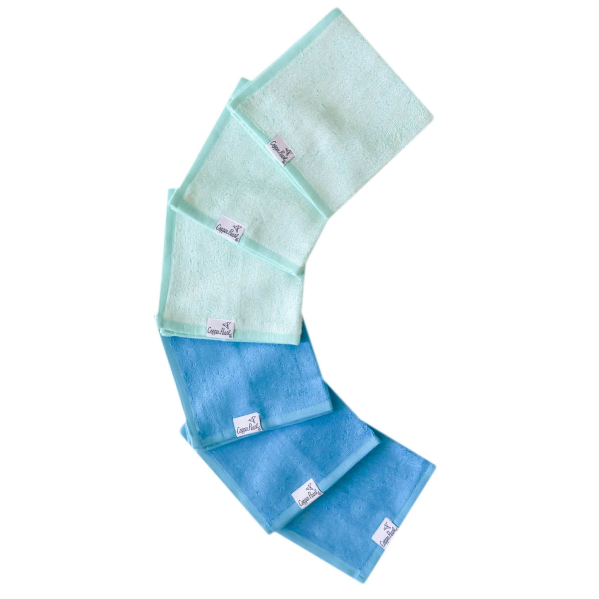Set of blue and green towels with brand labels on a white background