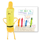 A yellow crayon-shaped plush toy stands in front of a printed book or card titled "The Day the Crayons Quit" on a plain white background.