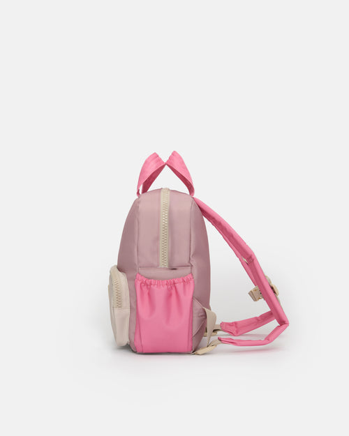 A small pink backpack with a front pocket and adjustable shoulder strap, photographed against a plain light gray background.