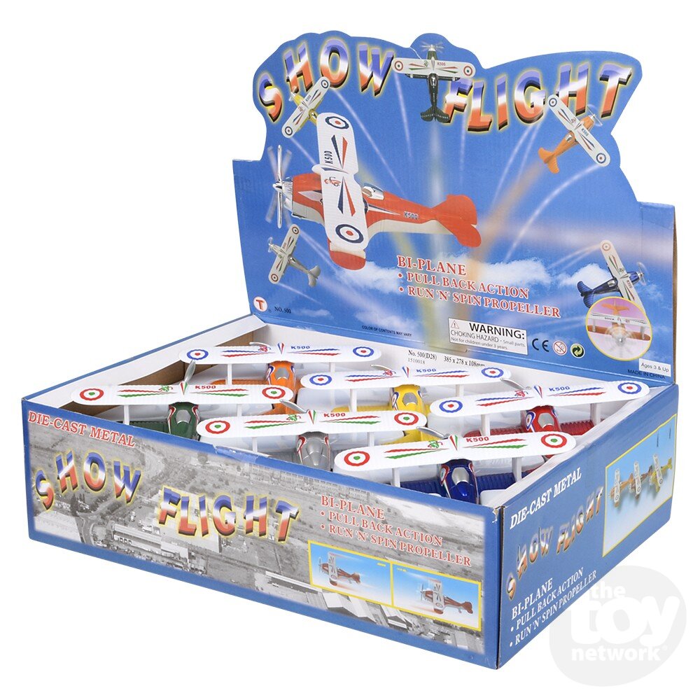 Display box of 'Show Flight' die-cast metal bi-plane toys with promotional graphics.