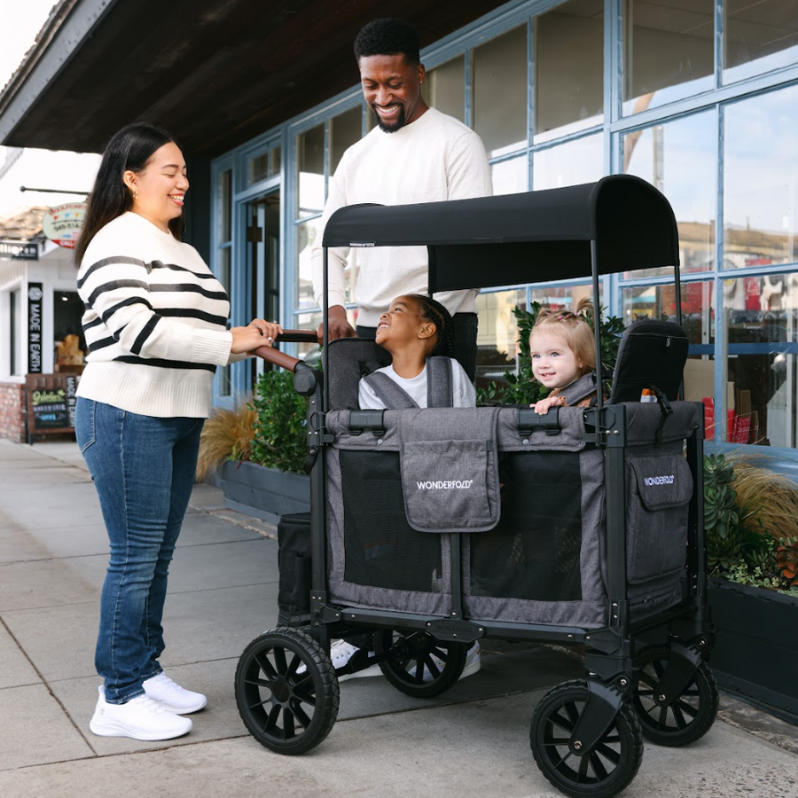 Family with a black and gray stroller in an urban setting