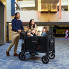 Family with children in a black wagon in a mall setting