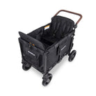 A black WonderWag stroller wagon with a brown handlebar, shown from a high-angle perspective on a clean white background.