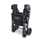 Black stroller with folded seat and bag on a white background