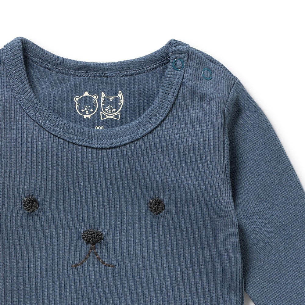 Close-up of a blue baby outfit with bear ears and nose on a white background