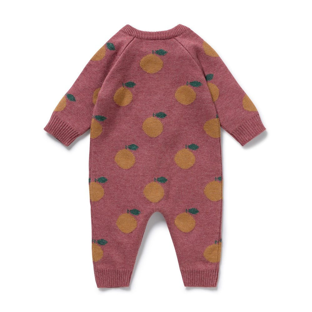 Pink baby romper with orange pattern on a white background