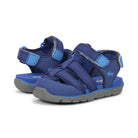 Pair of blue children's sandals with gray soles on a white background