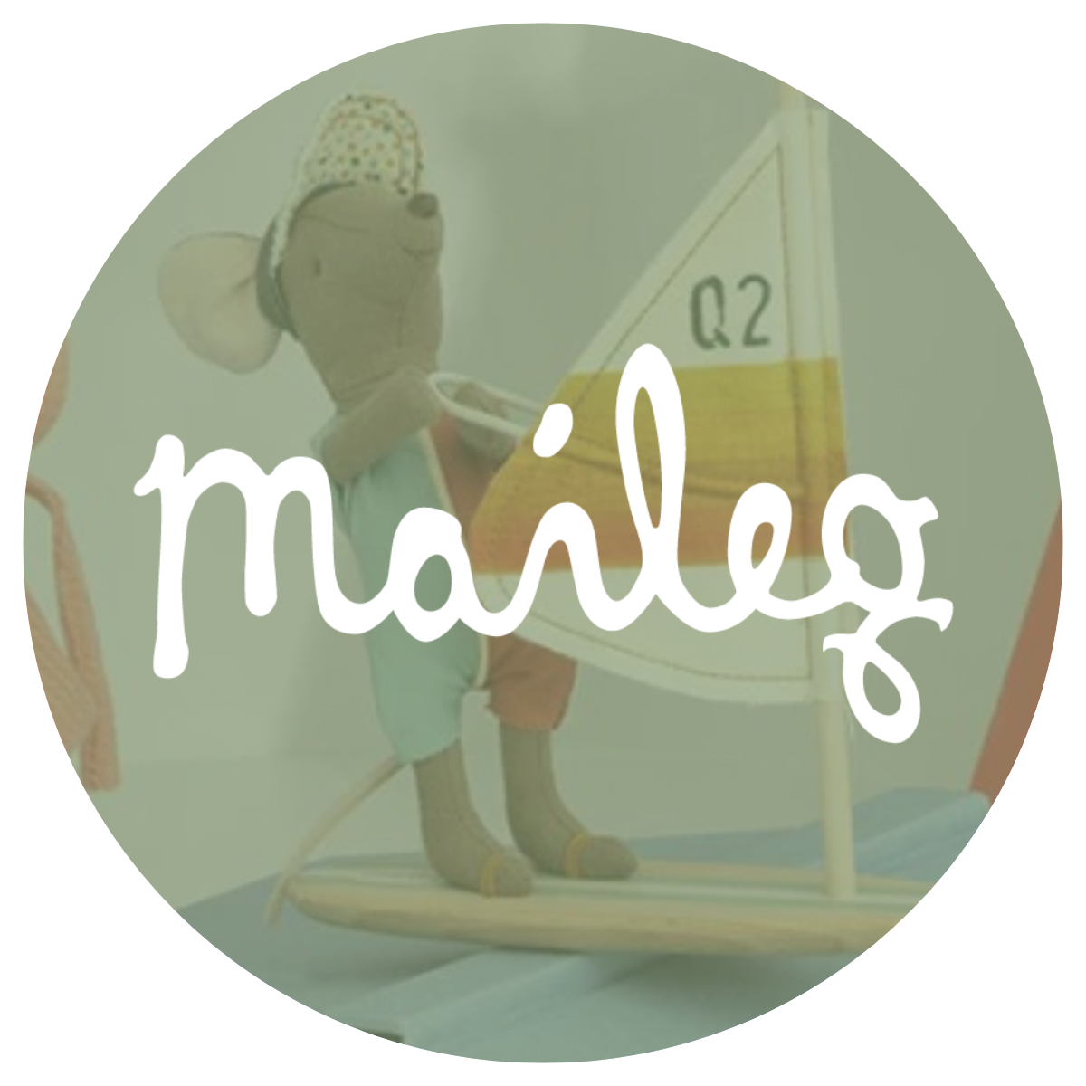 Stuffed animal on a sailboat with 'maileg' branding