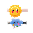 Two colorful hair clips shaped like a sun and a cloud on a white background