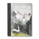 Book cover with illustration of a rabbit and text 'you belong here' on a white background