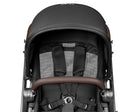 Close-up of a baby stroller with a black canopy and brown accents on a white background