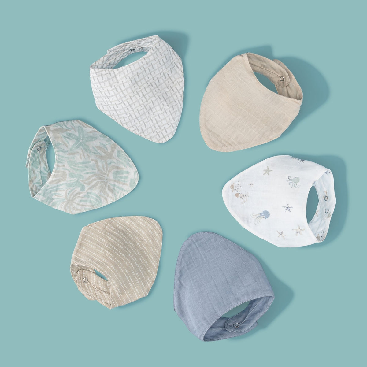 Set of baby bibs in various patterns on a light blue background