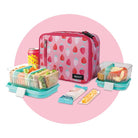 Pink lunch bag with strawberry pattern and contents on a pink background