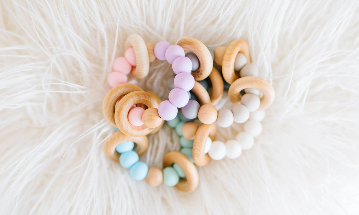 Colorful beaded bracelets on a white fluffy surface