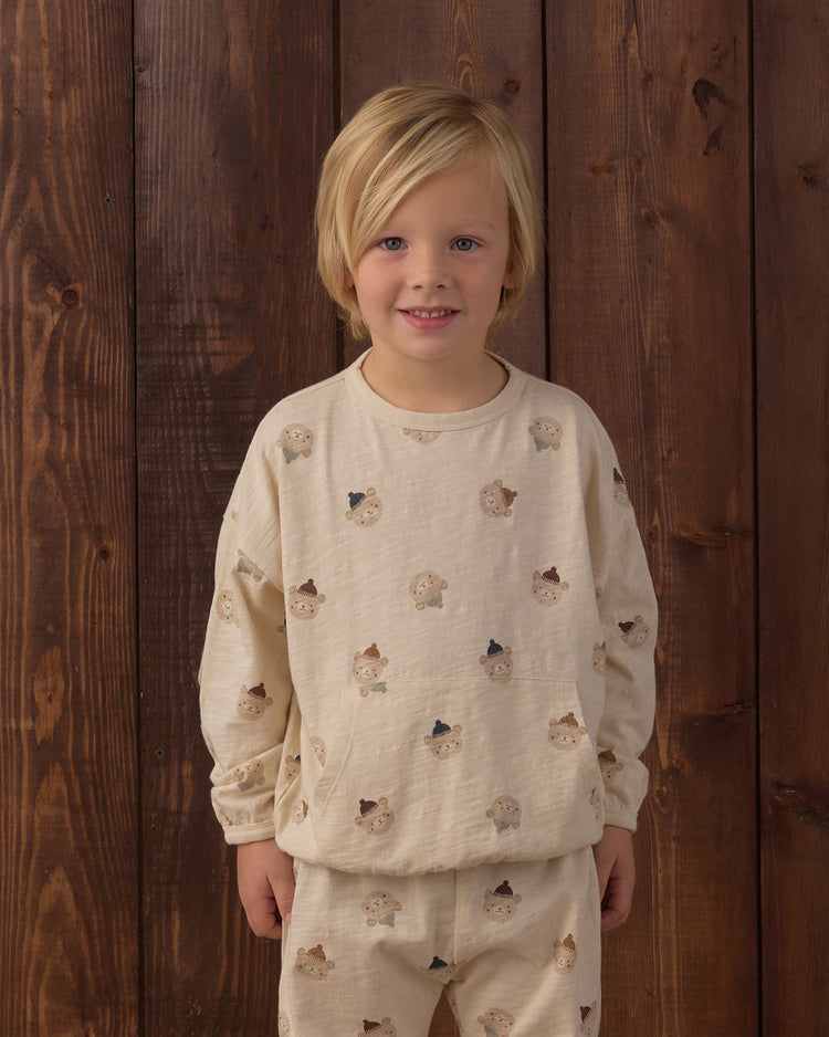 A child wearing the Rylee + Cru Winter Bears matching long-sleeve sweatshirt and pant set featuring an all-over patterned bear print.