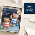 Package of 'Silly Swimmers' bath toys with two teddy bears in swim attire on a beige background.
