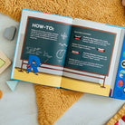 Open book with educational content on a yellow textured surface