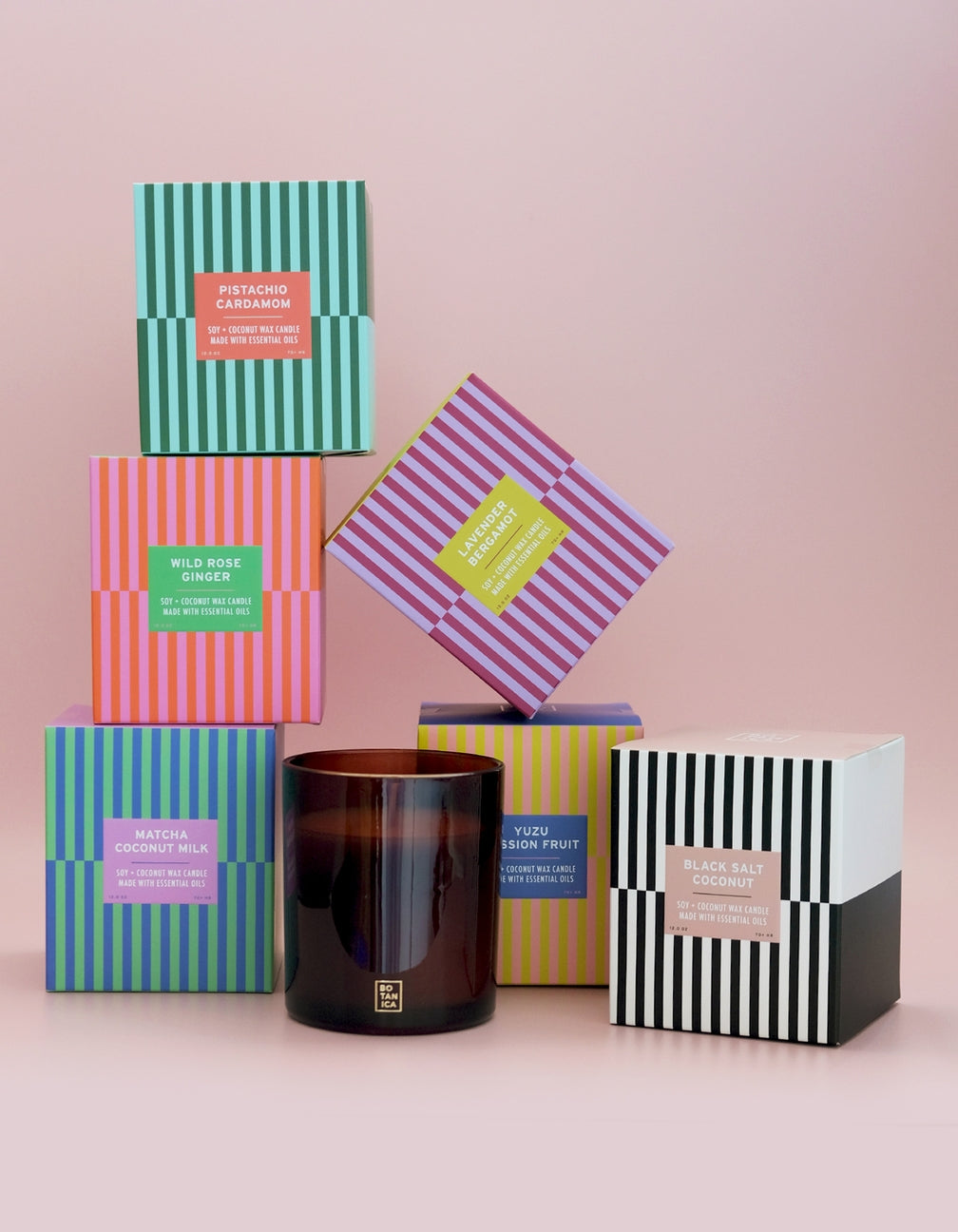 Collection of colorful boxes with candles on a pink background