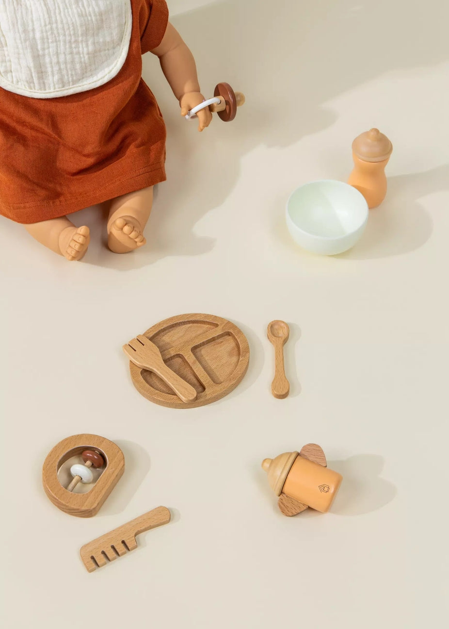 Wooden toys and a doll on a neutral background