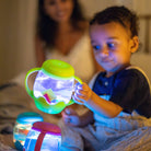 Child playing with a colorful light-up toy in a cozy indoor setting
