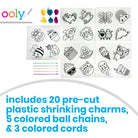 Ooly pre-cut plastic shrinking charms kit showing multiple sheets of black line-art cartoon charms, three colorful ball chains, and three colored cords, with text stating it includes 20 pre-cut plastic shrinking charms, 5 colored ball chains, and 3 colored cords.