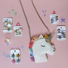 Unicorn headband with decorative hair clips on a pink background
