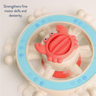 Toy wheel with a red crab-shaped center on a light background