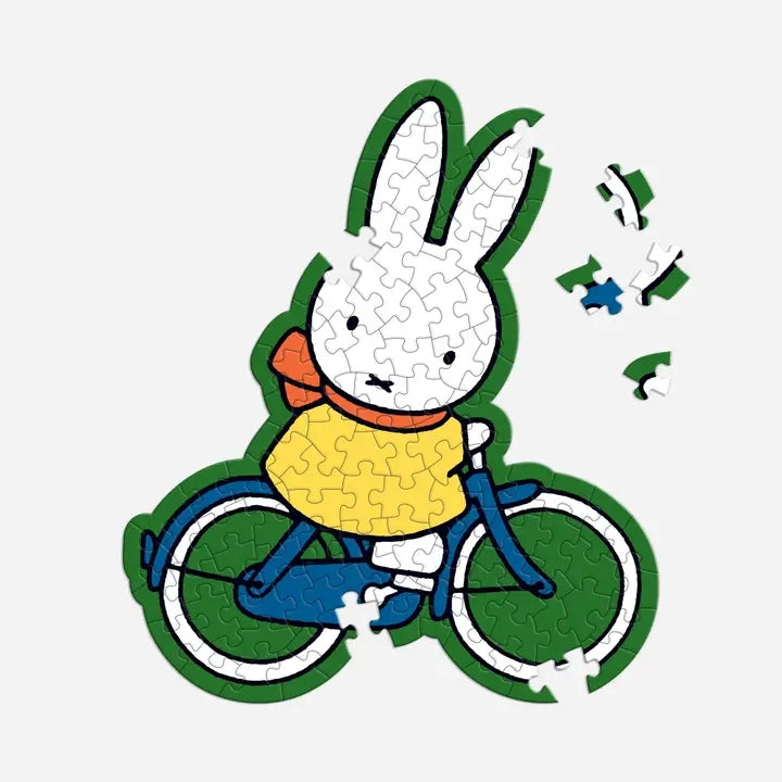 Jigsaw puzzle of a cartoon rabbit on a bicycle with missing pieces.