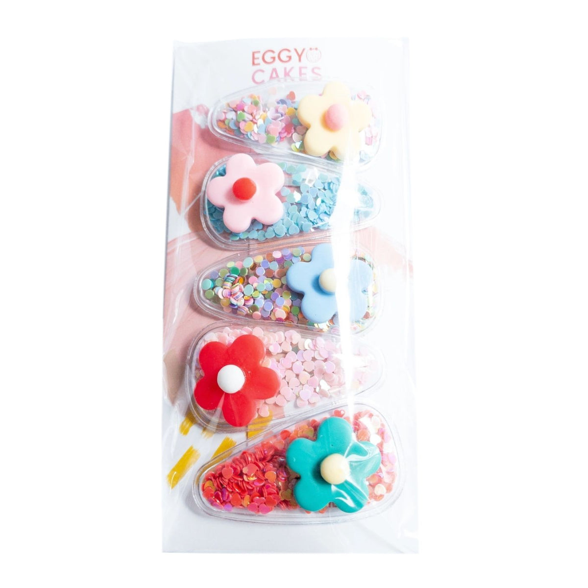 Packaged toy set with colorful flower-shaped containers on a white background
