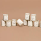 Collection of candles with labels on a beige background