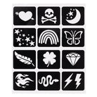 A sheet of twelve Tattoo Flair stick-on stencils against a white background, featuring a grid of white cut-out designs on black rectangular backing squares, including a heart pierced by an arrow, a skull and crossbones, a crescent moon with stars, a cluster of stars, a rainbow, a butterfly, a feather, a four-leaf clover, a diamond, a swirling tribal pattern, a snake, and lightning bolts.