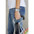 Person holding a bag with a focus on the hand and jeans